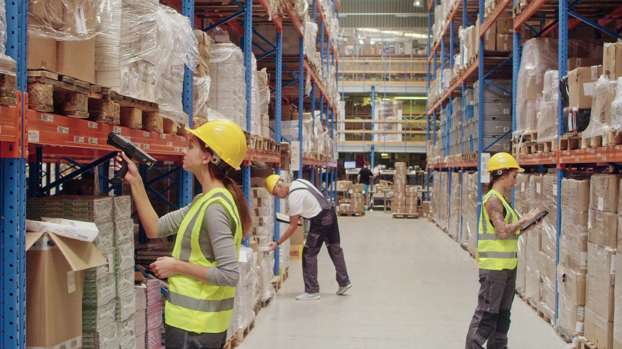 Warehouse worker scanning goods with a handheld computer